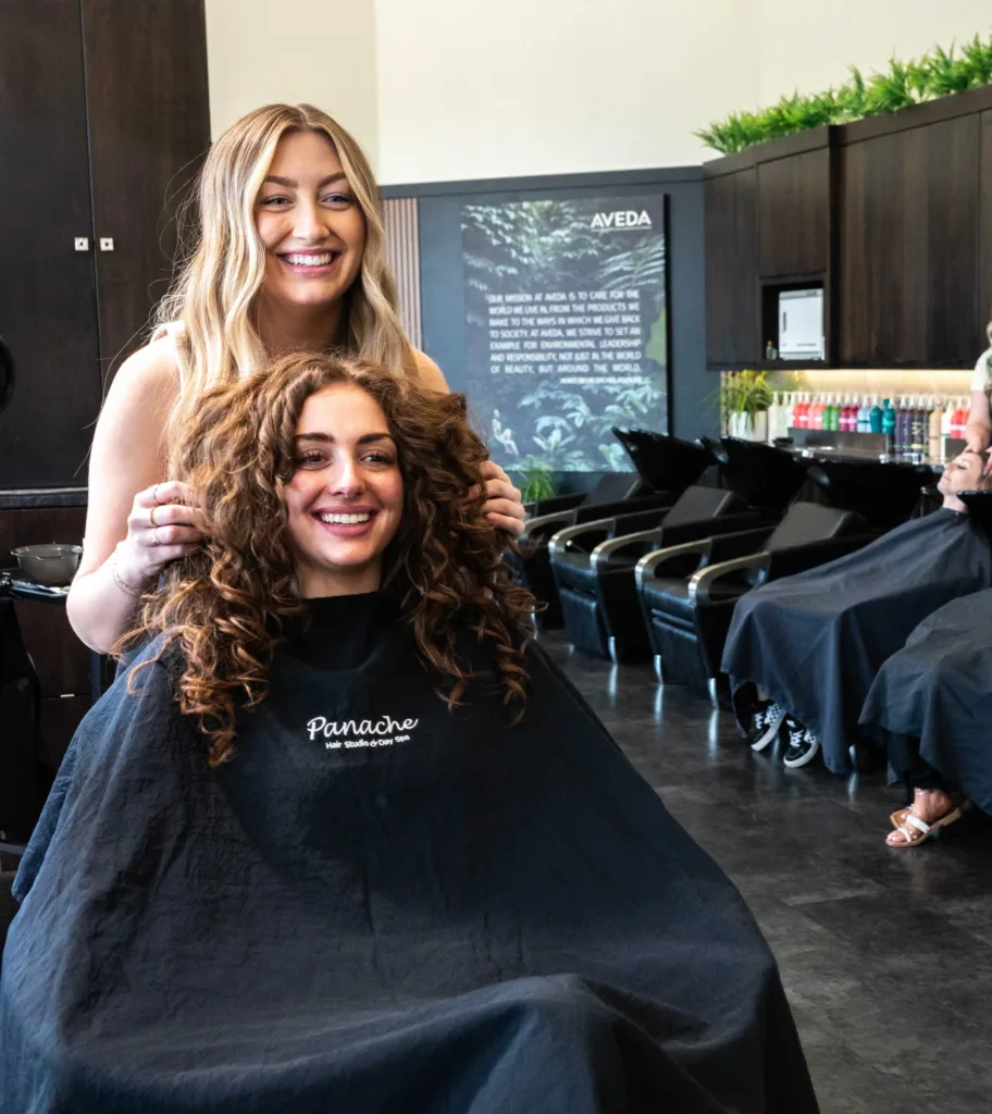 A hair stylist, and her client, celebrating a beautiful new haircut with the latest in botanical treatments from Aveda, at Panache Hair Studio & Day Spa, in the heart of Boise's metropolitan area, in the Village at Meridian, Idaho.