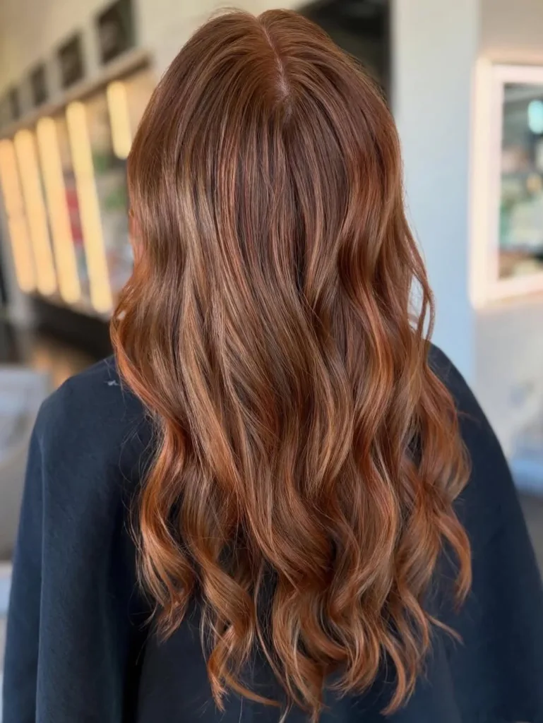 Autumn auburn and copper highlighted hair on a brunette client of Panache hair salon. Fall is the season of change, book an appointment today.